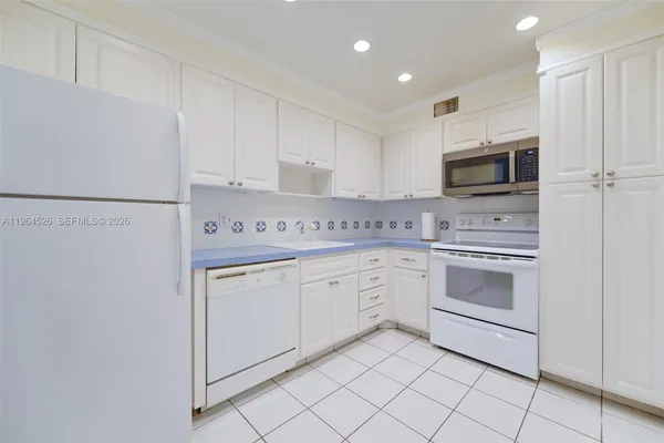a view of cabinets a washer and dryer