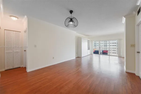 a view of empty room with wooden floor