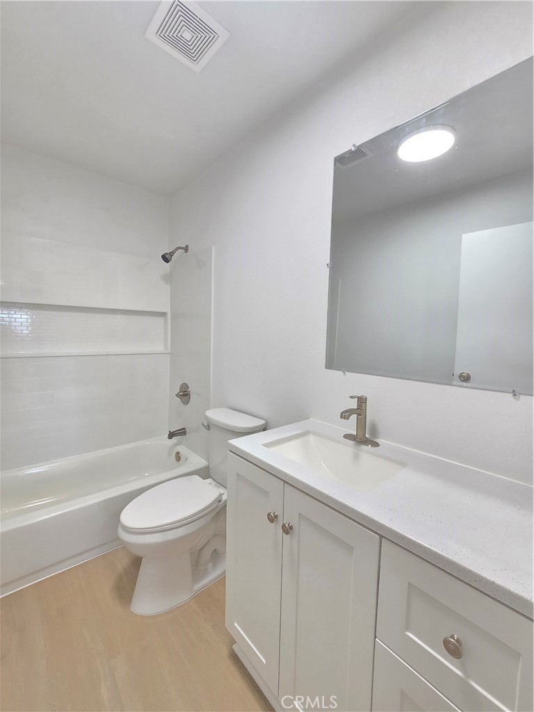 8249 Catalpa Avenue, Unit A California City, CA 93505 - Photo 11 of 12 a bathroom with a sink a toilet and bathtub