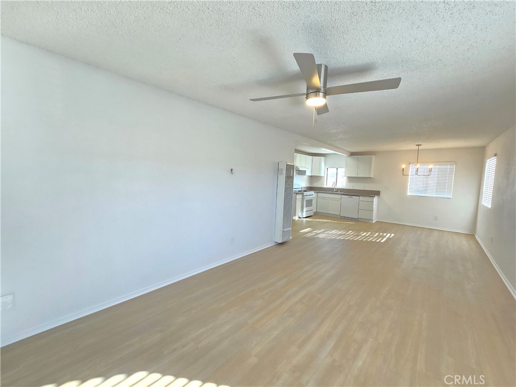 8249 Catalpa Avenue, Unit A California City, CA 93505 - Photo 12 of 12 an empty room with windows and ceiling fan