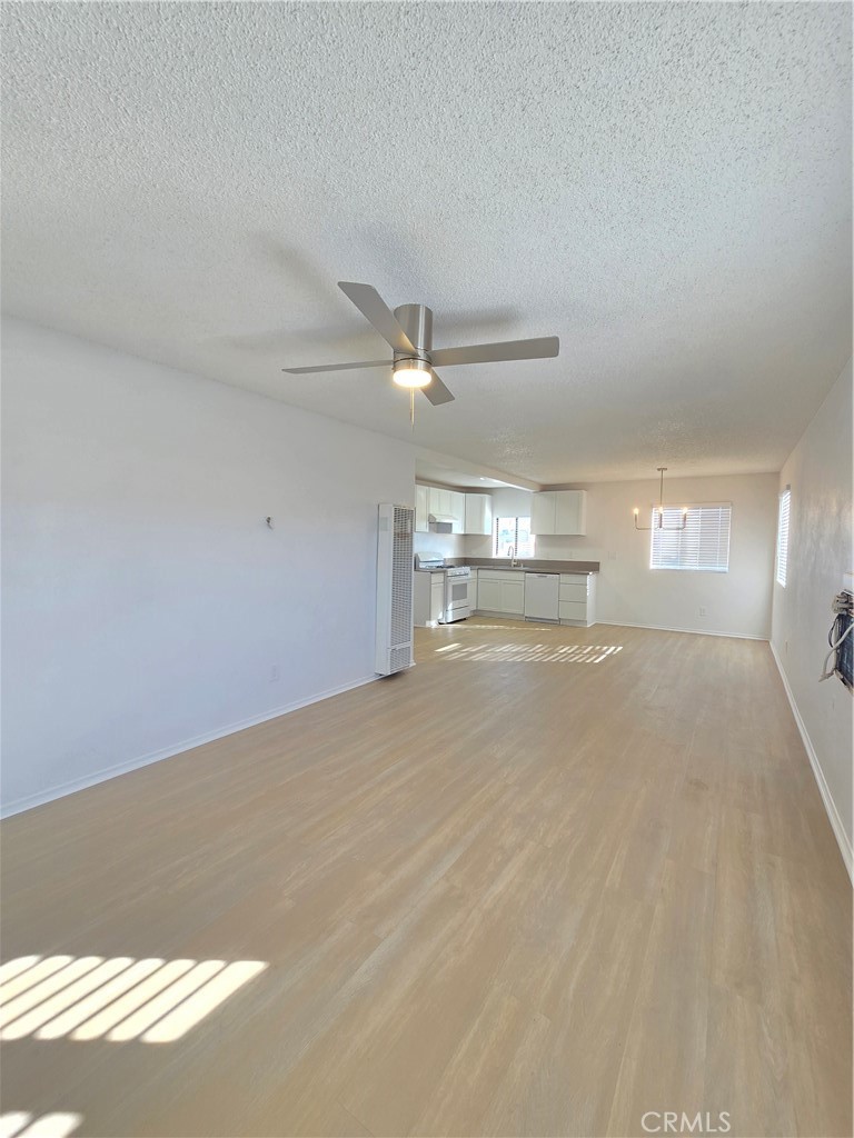 8249 Catalpa Avenue, Unit A California City, CA 93505 - Photo 7 of 12 a view of empty room with wooden floor