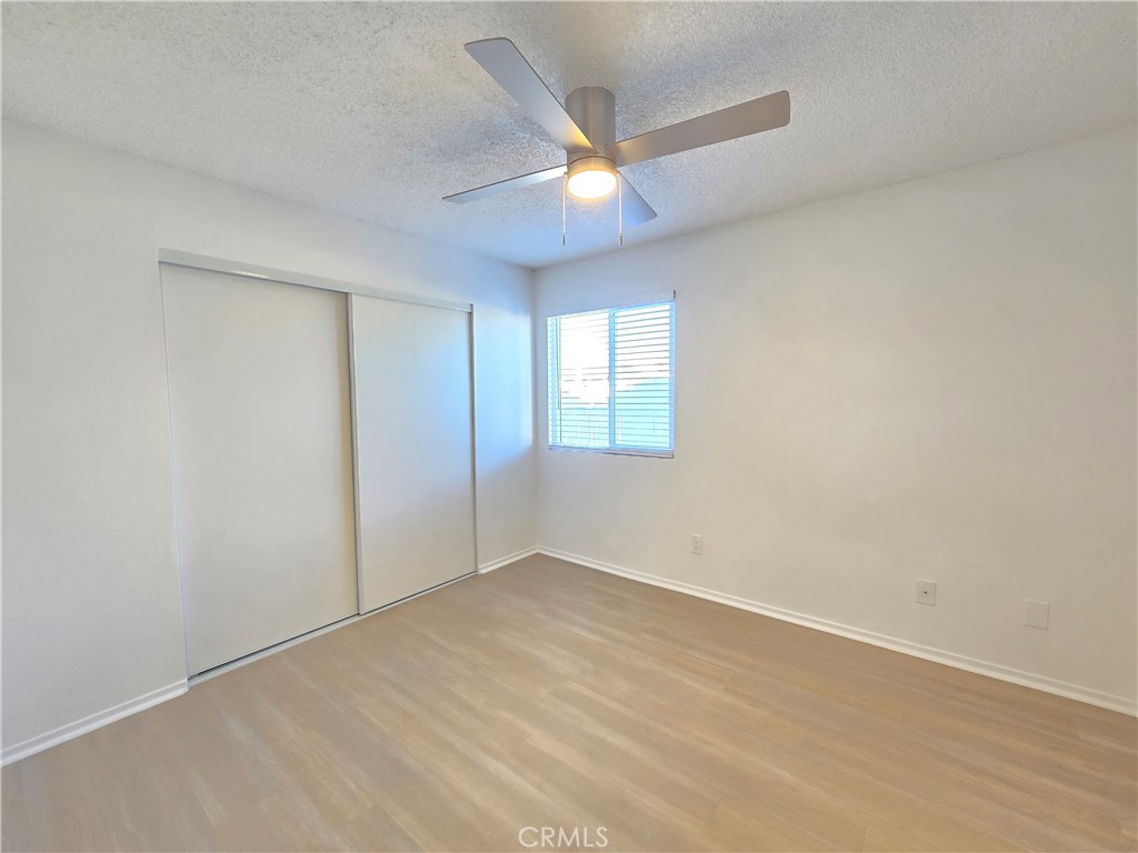 8249 Catalpa Avenue, Unit A California City, CA 93505 - Photo 10 of 12 an empty room with a ceiling fan and a window