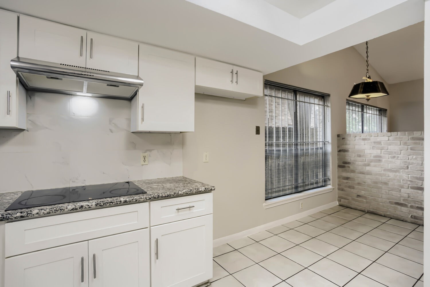 10103 Inwood Shadows Street Houston, TX 77088 - Photo 9 of 32 a kitchen with white cabinets and a stove