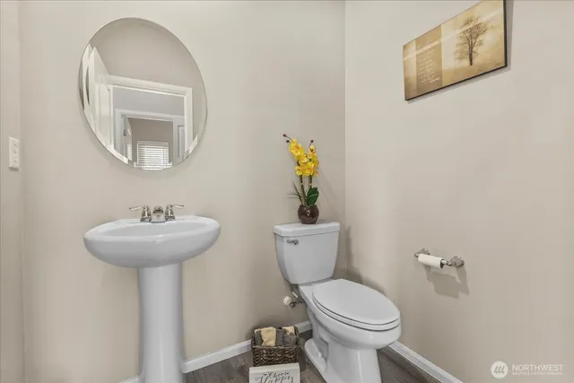 a bathroom with a toilet a sink and a mirror