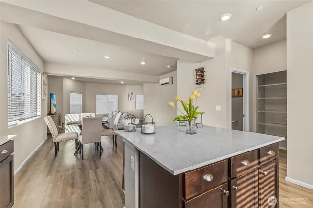 a kitchen with a table chairs and wooden floor