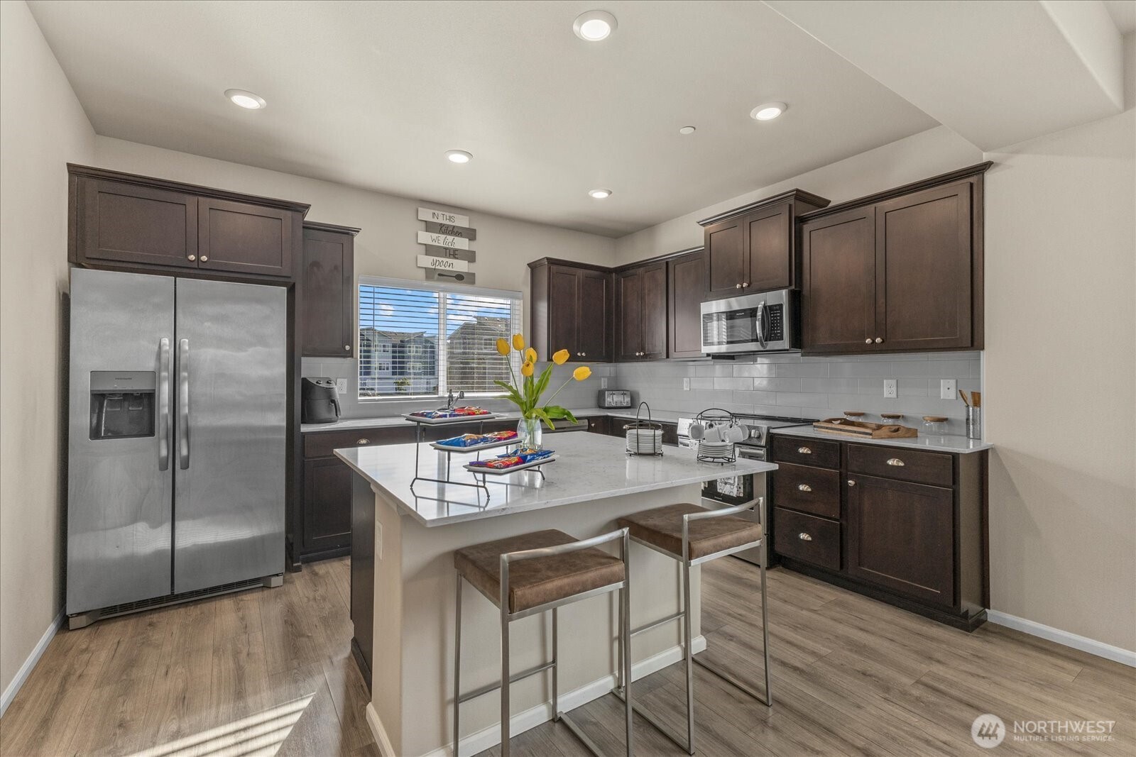 17401 118th Ave Court East, Unit A Puyallup, WA 98374 - Photo 10 of 25 a kitchen with stainless steel appliances granite countertop a refrigerator stove microwave and cabinets
