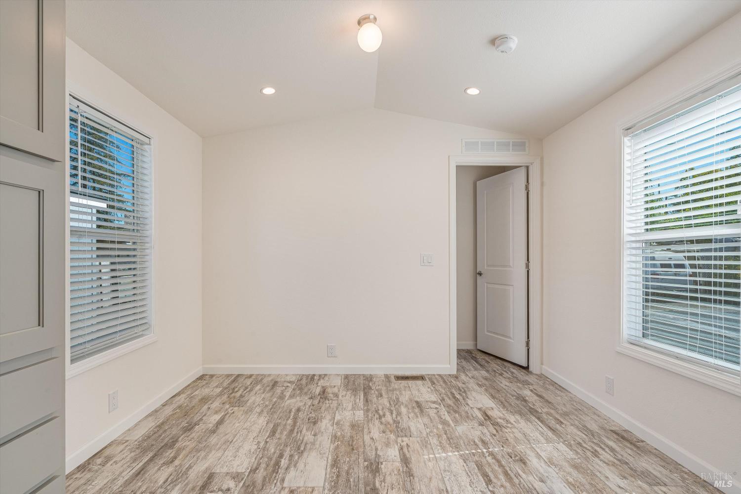 101 Colgan Avenue, Unit 24 Santa Rosa, CA 95404 - Photo 11 of 21 a view of an empty room with wooden floor and a window
