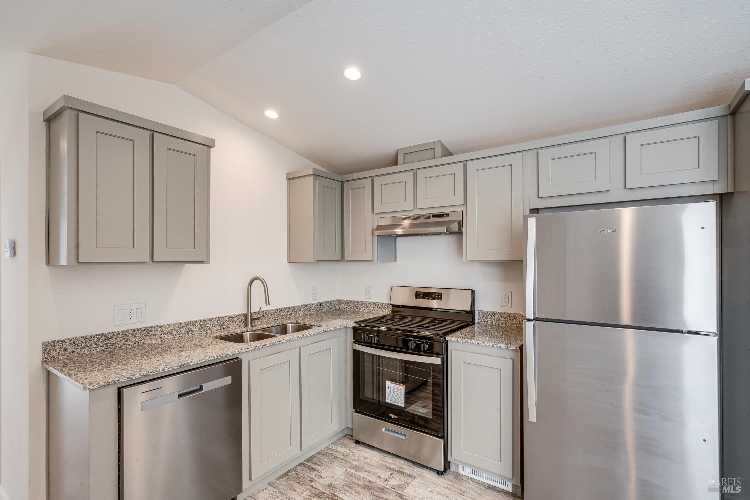 101 Colgan Avenue, Unit 24 Santa Rosa, CA 95404 - Photo 5 of 21 a kitchen with a refrigerator sink and cabinets