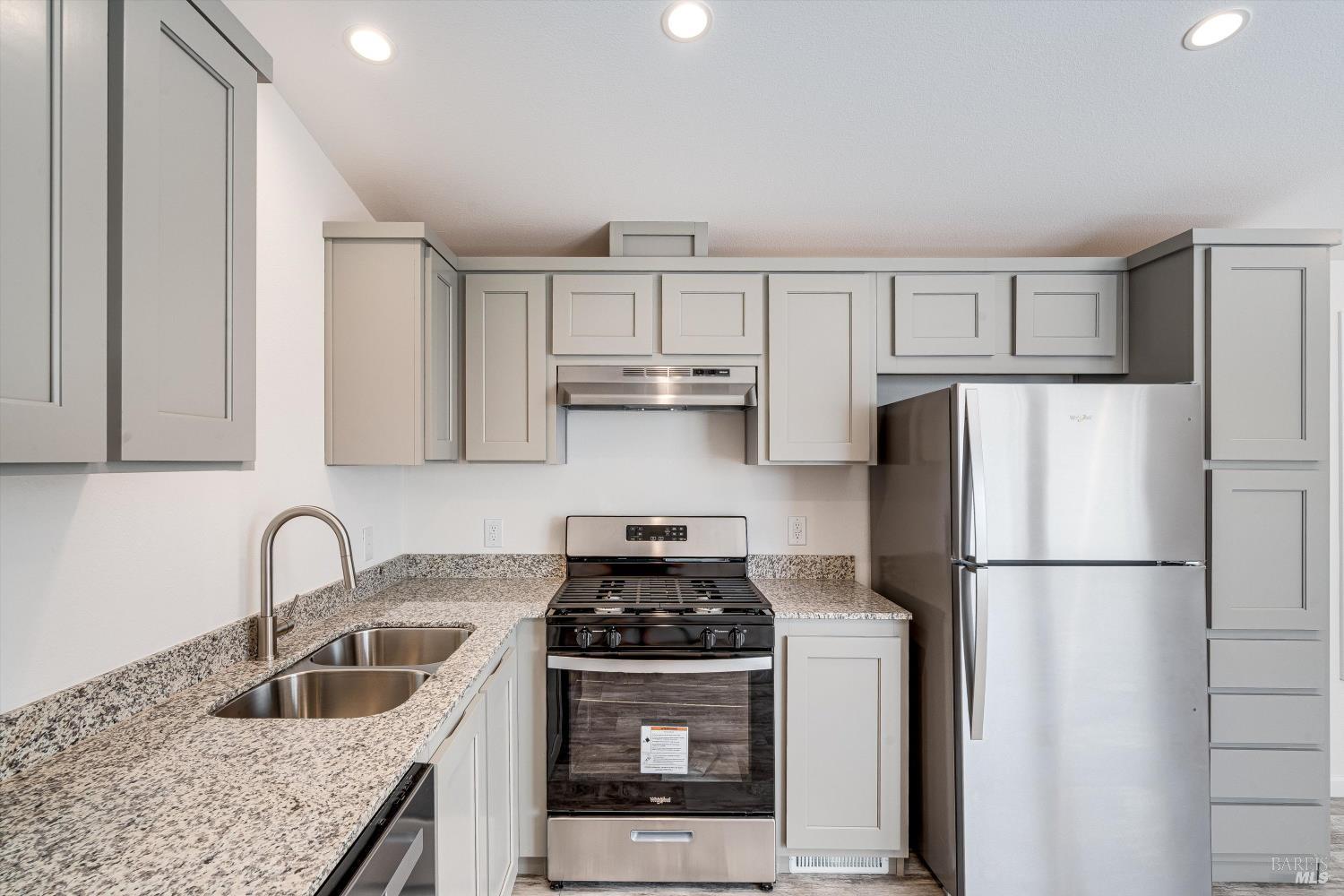101 Colgan Avenue, Unit 24 Santa Rosa, CA 95404 - Photo 6 of 21 a kitchen with stainless steel appliances granite countertop a refrigerator stove and sink