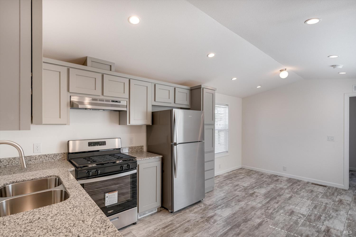 101 Colgan Avenue, Unit 24 Santa Rosa, CA 95404 - Photo 7 of 21 a kitchen with stainless steel appliances granite countertop a refrigerator sink and stove