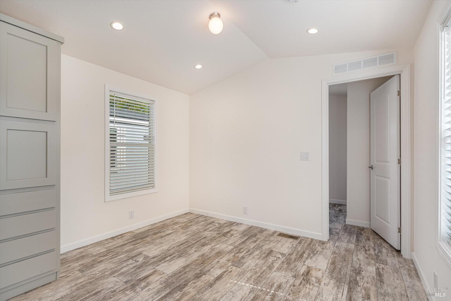 101 Colgan Avenue, Unit 24 Santa Rosa, CA 95404 - Photo 8 of 21 a view of an empty room with wooden floor and a window
