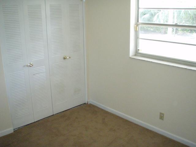 9844 Liberty Road Boca Raton, FL 33434 - Photo 8 of 8 a view of a small space with wooden floor and a window