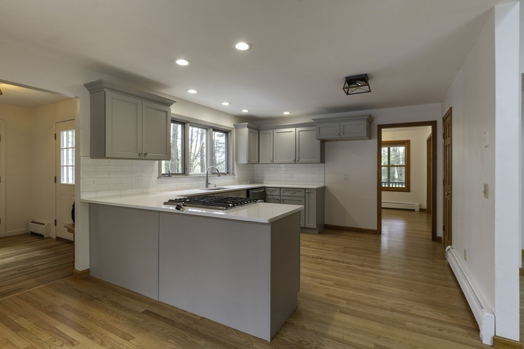 91 Main Road Westhampton, MA 01027 - Photo 11 of 35 a kitchen with a stove sink and cabinets
