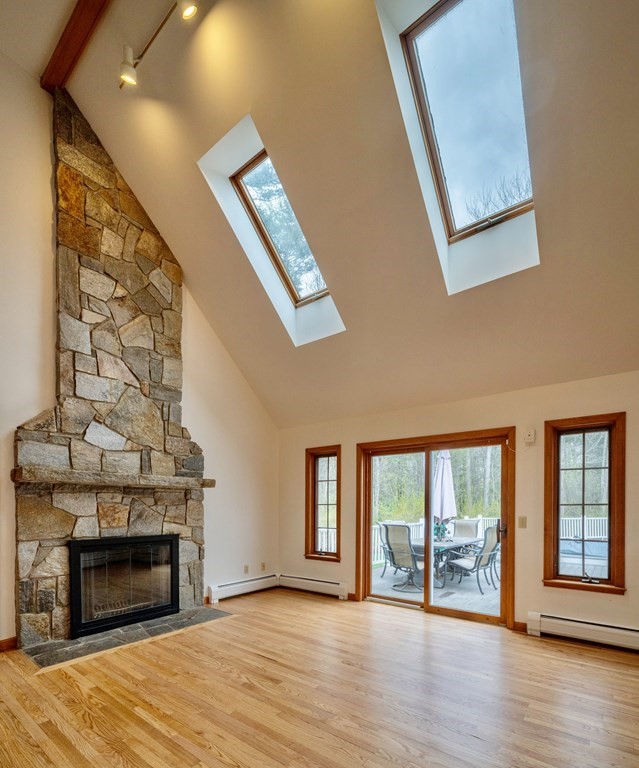 91 Main Road Westhampton, MA 01027 - Photo 12 of 35 a view of an empty room with wooden floor fireplace and a window