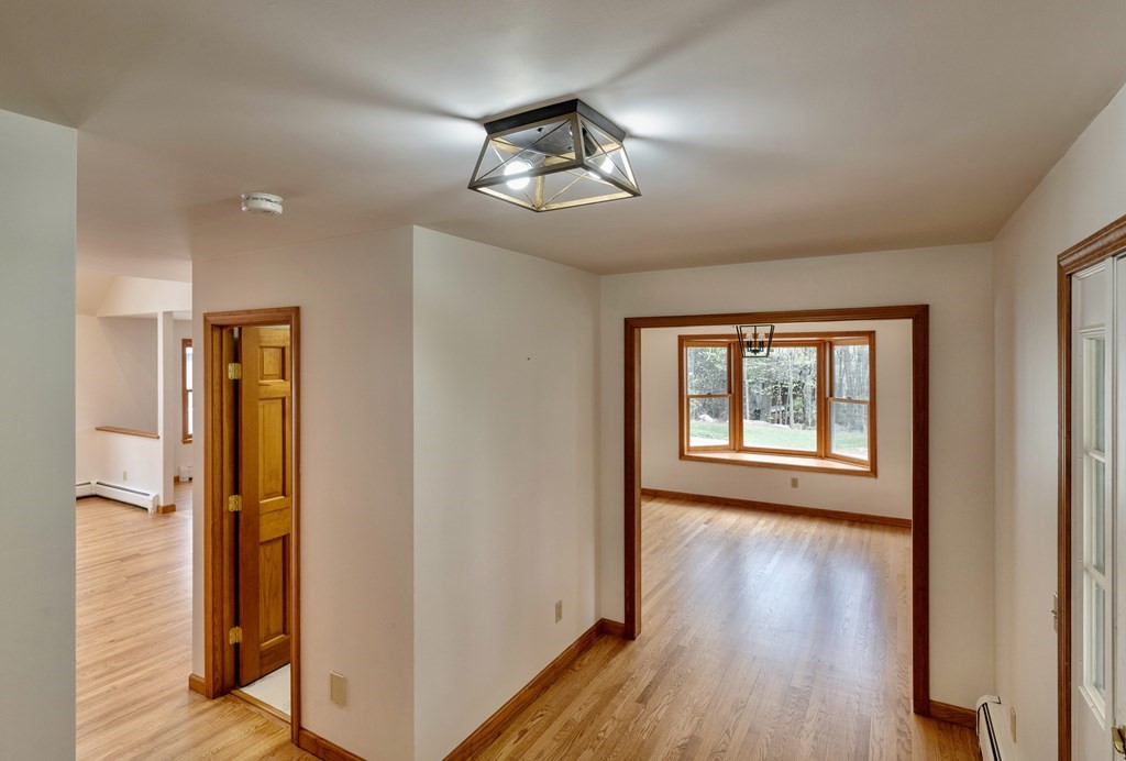 91 Main Road Westhampton, MA 01027 - Photo 14 of 35 a view of an empty room with wooden floor and a window