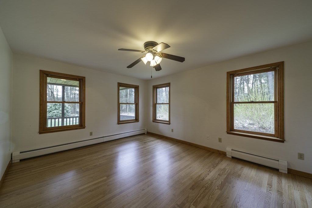 91 Main Road Westhampton, MA 01027 - Photo 17 of 35 a view of empty room with wooden floor and fan