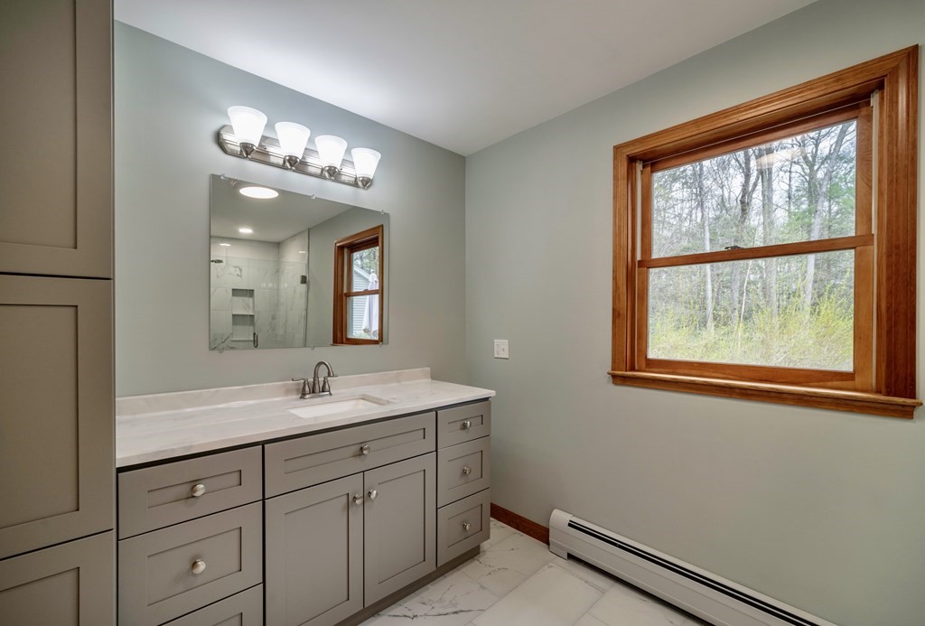 91 Main Road Westhampton, MA 01027 - Photo 19 of 35 a bathroom with a double vanity sink and a mirror