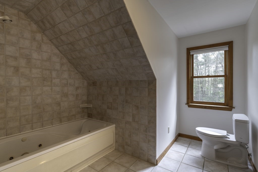 91 Main Road Westhampton, MA 01027 - Photo 25 of 35 a bath room with a toilet and a bath tub