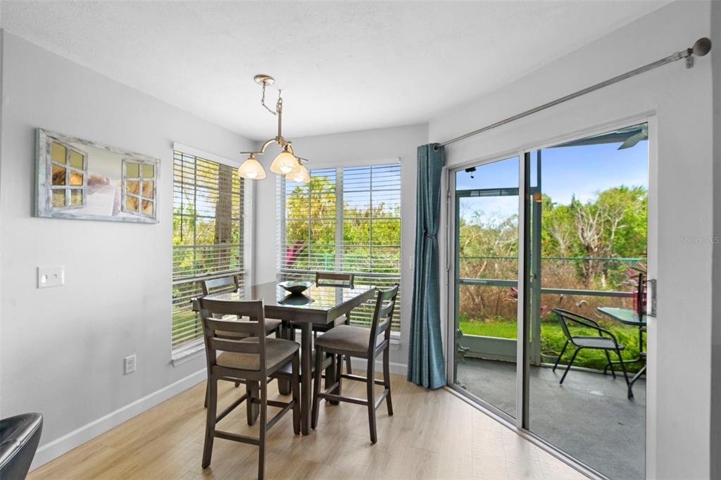 7470 Highway 1, Unit 105 Cocoa, FL 32927 - Photo 12 of 37 a view of a dining room with furniture window and wooden floor
