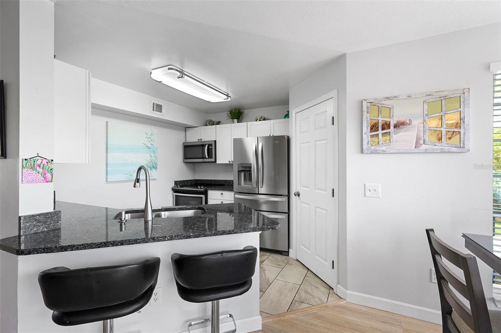 7470 Highway 1, Unit 105 Cocoa, FL 32927 - Photo 15 of 37 a kitchen with stainless steel appliances granite countertop a sink refrigerator and cabinets