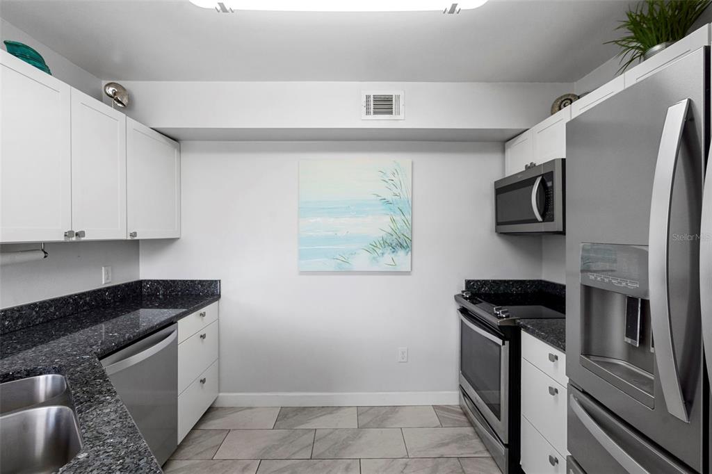 7470 Highway 1, Unit 105 Cocoa, FL 32927 - Photo 17 of 37 a kitchen with a sink and a stove top oven