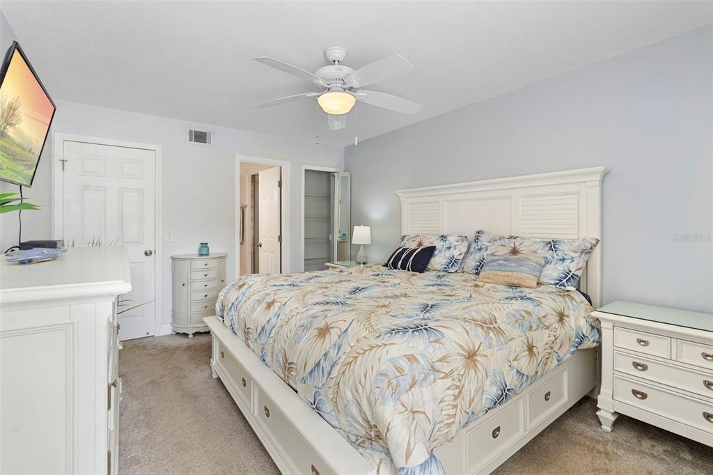 7470 Highway 1, Unit 105 Cocoa, FL 32927 - Photo 18 of 37 a spacious bedroom with a bed and a chandelier