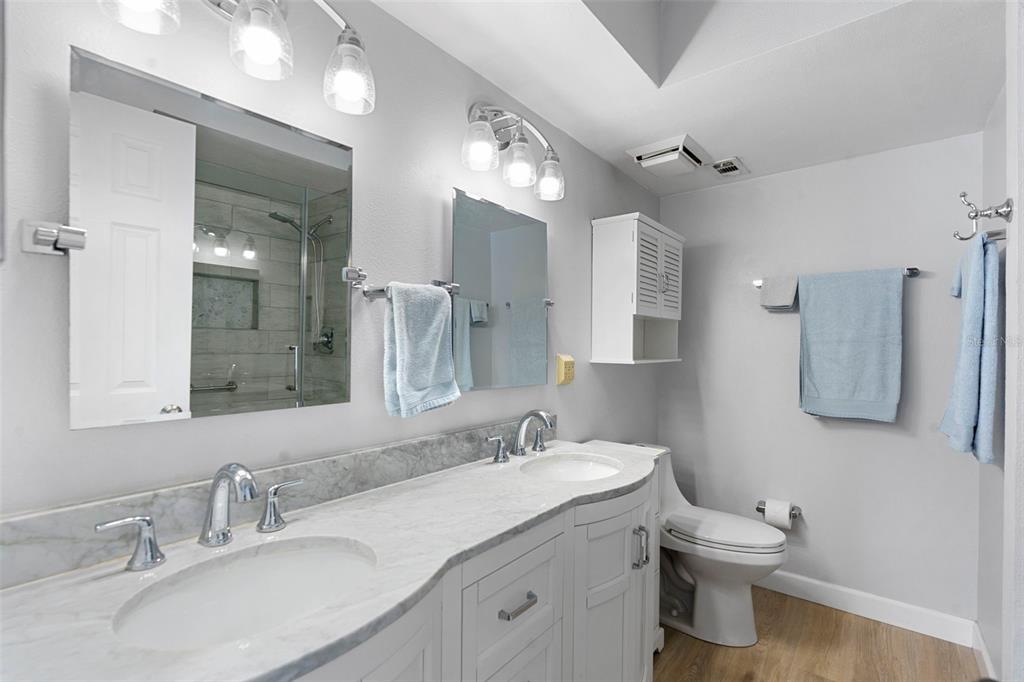 7470 Highway 1, Unit 105 Cocoa, FL 32927 - Photo 20 of 37 a bathroom with a granite countertop sink a toilet and a mirror