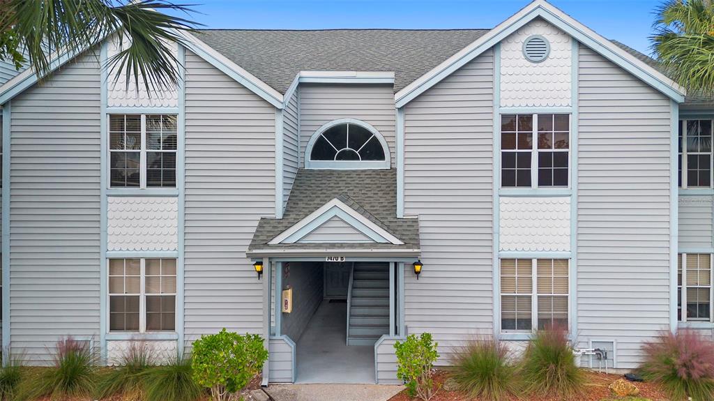 7470 Highway 1, Unit 105 Cocoa, FL 32927 - Photo 2 of 37 a front view of a house with a yard and garage