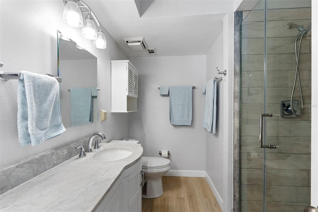 7470 Highway 1, Unit 105 Cocoa, FL 32927 - Photo 21 of 37 a bathroom with a granite countertop sink toilet and shower
