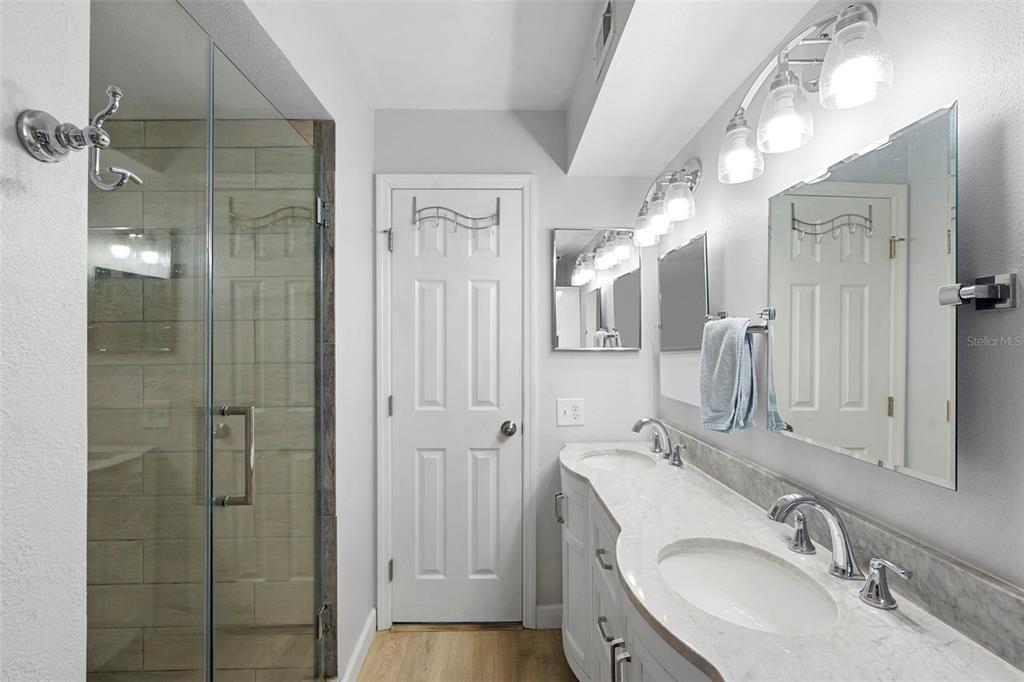 7470 Highway 1, Unit 105 Cocoa, FL 32927 - Photo 22 of 37 a bathroom with a granite countertop shower sink and mirror