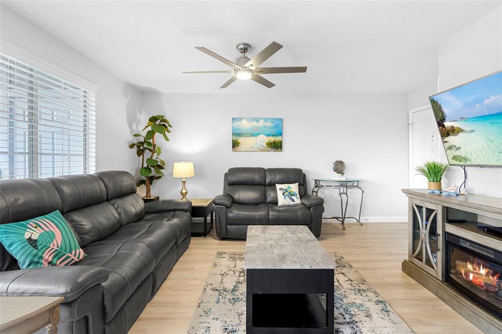 7470 Highway 1, Unit 105 Cocoa, FL 32927 - Photo 7 of 37 a living room with furniture and a fireplace
