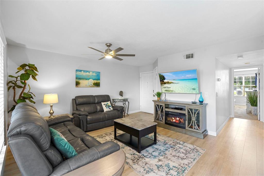 7470 Highway 1, Unit 105 Cocoa, FL 32927 - Photo 8 of 37 a living room with furniture and a fireplace