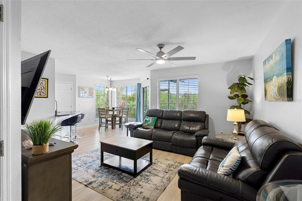 7470 Highway 1, Unit 105 Cocoa, FL 32927 - Photo 9 of 37 a living room with furniture a flat screen tv and a potted plant