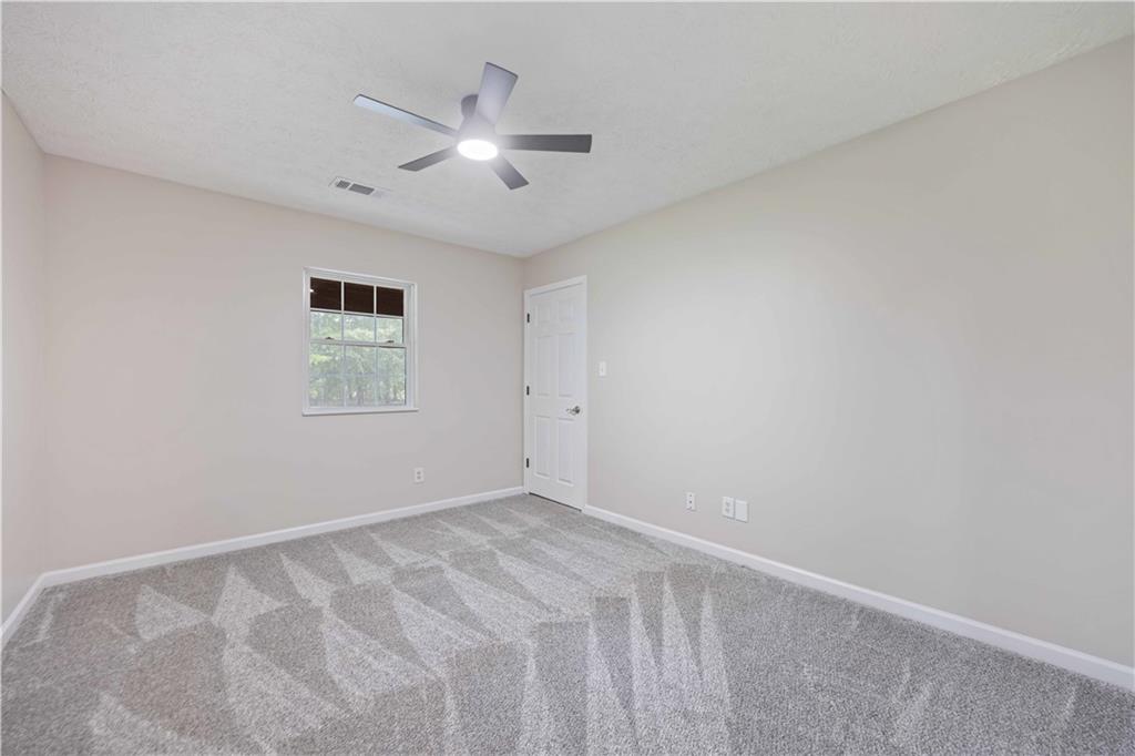 25 Gas Line Road Phenix City, AL 36870 - Photo 30 of 52 Empty room with carpet and ceiling fan