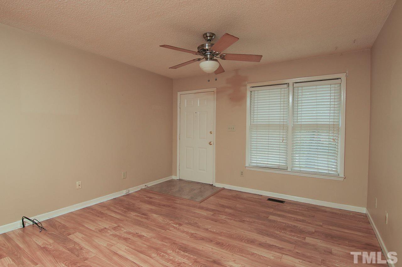 2305 Merganzer Road Raleigh, NC 27616 - Photo 3 of 10 a view of an empty room with wooden floor and a window