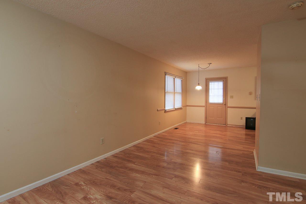 2305 Merganzer Road Raleigh, NC 27616 - Photo 4 of 10 a view of an empty room with wooden floor and a window
