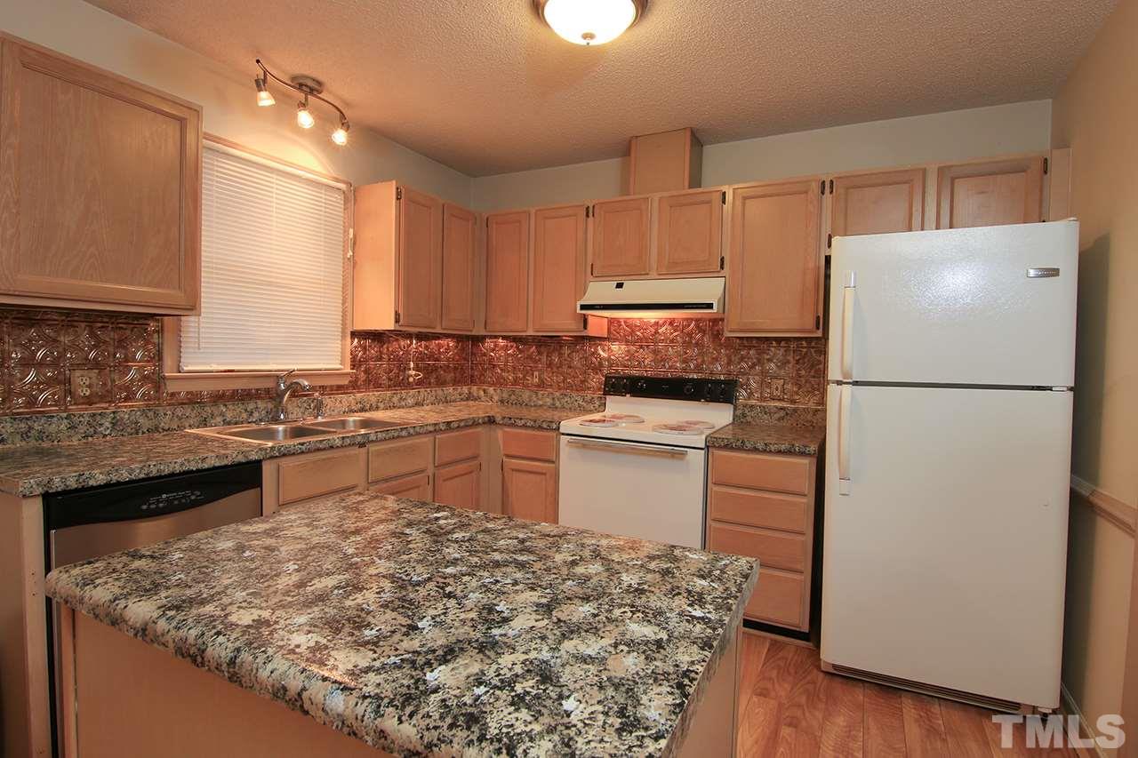 2305 Merganzer Road Raleigh, NC 27616 - Photo 5 of 10 a kitchen with a refrigerator sink and stove