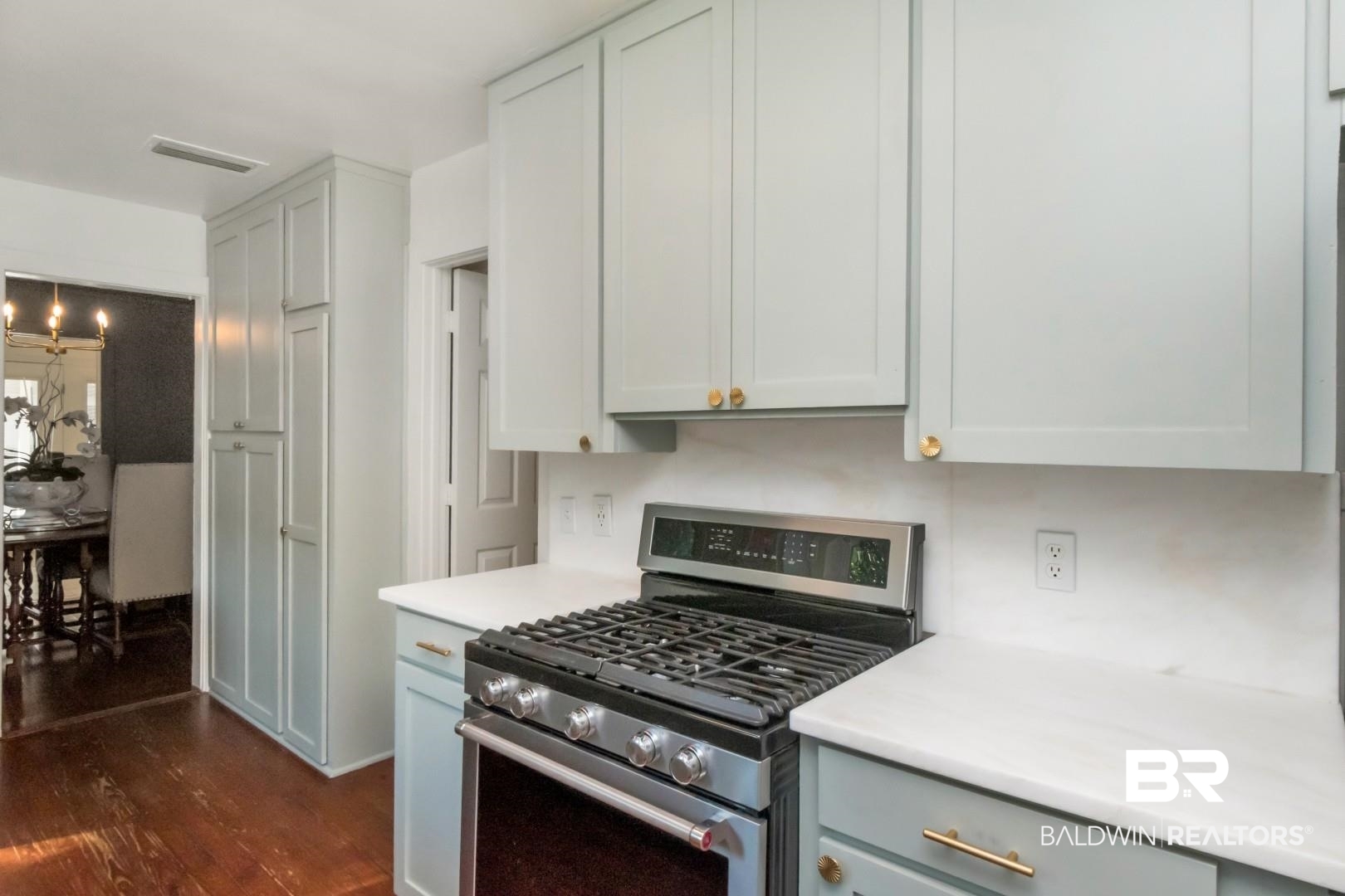 18 Princess Anne Road Mobile, AL 36608 - Photo 13 of 41 Kitchen featuring stainless steel range with gas cooktop, dark wood-style flooring, and white cabinets