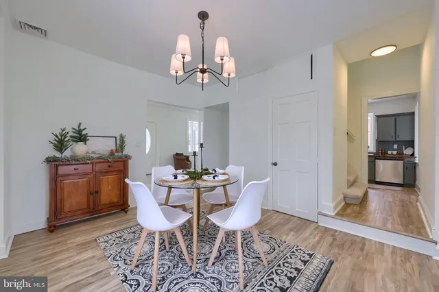 a view of a dining room with furniture wooden floor and a chandelier