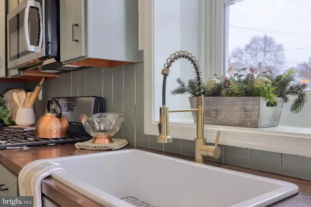 a view of living room with furniture and a fireplace
