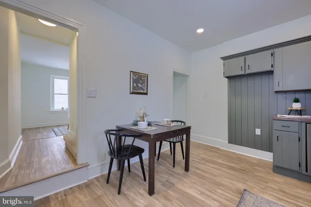 a view of a kitchen area with furniture and wooden floor