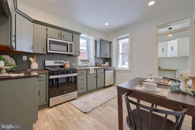 a kitchen with a sink cabinets and stainless steel appliances