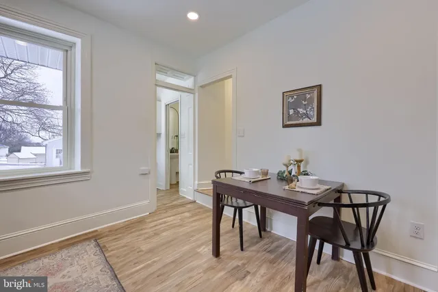 a view of a workspace with furniture and wooden floor
