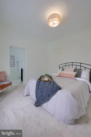 a bedroom with a bed and a lamp