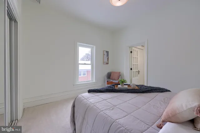 a bedroom with a bed and window