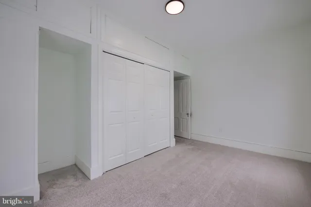 an empty room with closet area