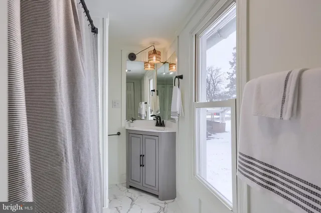 a bathroom with a mirror and a shower