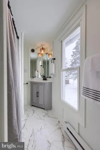 a bathroom with a sink a mirror and a shower