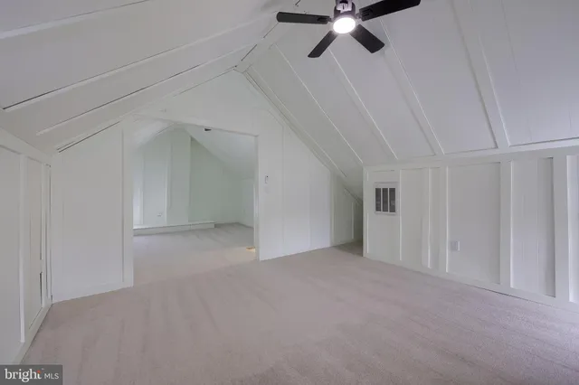 a view of an empty room with a ceiling fan