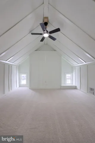 a view of a livingroom with a ceiling fan and window